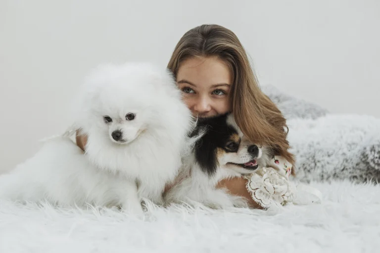 girl-cute-white-pups-sitting-bed